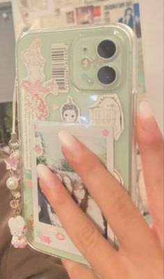 a person holding up a cell phone case with pictures on the front and back cover