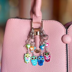 Add a bright pop of color and whimsy to your purse or handbag with these custom owl purse charms! Handcrafted with care and attention to detail, each owl purse charm is unique and full of personality. Our personalized bag charms are perfect for owl lovers - or anyone appreciates a unique jewelry accessory.  Each purse charm features a silver lobster clasp, sterling silver chain, owl pendant of your choice, and coordinating accent beads.  These cute little owls are the perfect way to personalize your purse or backpack, or could also be used as a zipper pull. Whether you are an animal lover or just looking to add some fun to your purse or bag, these adorable owl purse charms are sure to delight!  **If you don't see a color combination you like, please reach out!  We have many other colors av Purses With Charms, Cute Handmade Multicolor Keychains, Whimsical Charm Necklaces With Dangle Charms, Adjustable Novelty Charms Bracelets, Purse Jewelry Key Chains, Owl Purses Handbags, Owl Purse, Whimsical Owl, Colorful Owls