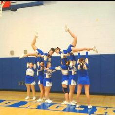 a group of cheerleaders standing on top of a basketball court