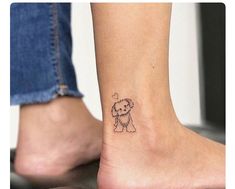 a small dog tattoo on the ankle