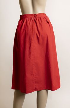 "FREE DOMESTIC SHIPPING! <3 ♥ Adorable vintage 1970s cherry red cotton skirt with front pockets and D-ring waistline! ♥ Nylon zipper in the back with a button closure. ♥ Cute deep, front pockets. ♥ Knee length, straight style cut. ♥ Fun D-ring waistline, lets you cinch the waist in if needed. Ends of strips will lay to the side (modeled to the back to show details) ♥ In great condition! Minimal wear (possibly from iron?) on seams. Cotton, made in Belgium! * measurements * Waist - 26\", could Red Midi Skirt With Pockets, Red Skirt With Elastic Waistband, Red Midi Skirt With Elastic Waistband, Red Cotton Flared Skirt Bottoms, Red Cotton Midi Skirt, Red Spring Skirt With Pockets, Red Skirt With Pockets For Spring, Red Full Skirt Bottoms With Pockets, Long Red Skirt With Pockets