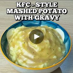 a bowl of mashed potatoes with gravy in it