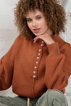 -Color: Burnt Brick -Mock neck -Center pearl buttons -Dropped shoulders -Relaxed fit with back center seam -Pullover style -Content: 65% Polyester 35% Acrylic -Hand wash/Line dry -Imported -Model is wearing a size Small Fall Turtleneck Top With Buttons, Chic Tops With Pearl Buttons For Fall, Chic Fall Tops With Pearl Buttons, Style Inspiration Winter, Pearl Buttons, Cardigan Jacket, Modern Fashion, Bottoms Pants, Fall Fashion