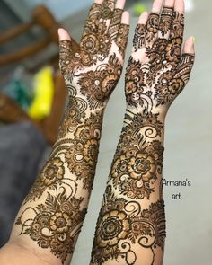 two hands with henna tattoos on them