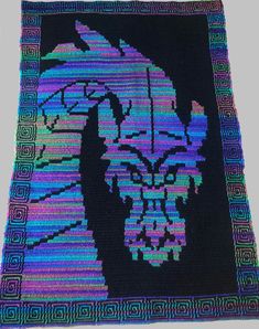 a crocheted afghan with an image of a man's head on it