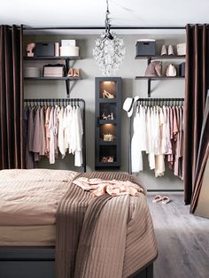 a bedroom with closets and clothes hanging on the wall next to it's bed