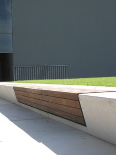 a skateboarder doing a trick on the side of a ramp in front of a building