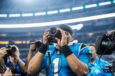 a football player taking a photo with his camera