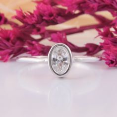 a close up of a ring with flowers in the background