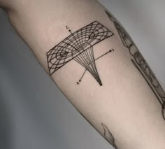 a man's arm with a tattoo on it that has an image of a kite flying in the sky