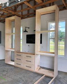 an unfinished room with shelves and cabinets in it