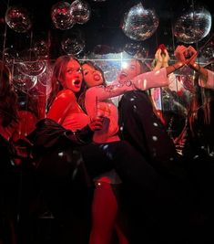 two women dancing in front of disco balls