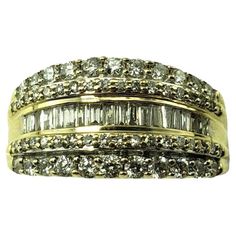 Vintage 10K Yellow Gold and Diamond Band Ring Size 7.5 JAGi Certified- This sparkling band features 18 baguette diamonds, 22 round brilliant cut diamonds* and 36 round single cut diamonds set in classic 10K yellow gold. Width: 10.6 mm. Shank: 2.5 mm. *Chip noted to one stone on end. Total diamond weight: .88 ct. Diamond clarity: SI1-SI2 Diamond color: I-J Ring size: 7.5 Stamped: 10K Weight: 4.7 gr./ 3.1 dwt. JAGi Certificate included. Very good condition, professionally polished. Will come packaged in a gift box or pouch (when possible) and will be shipped U.S. Priority Mail Insured. DV100923/17KCS Exquisite Yellow Gold Baguette Cut Jewelry, Yellow Gold Cubic Zirconia Rings, Fine Jewelry, Star-shaped Yellow Gold Cubic Zirconia Jewelry, Canary Yellow Diamond Ring 1stdibs, Dazzling Yellow Diamond-cut Jewelry, Gold Diamond Band, Diamond Rings Bands, Baguette Diamond, Diamond Clarity