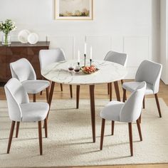 a dining table with six chairs around it