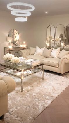 a living room filled with furniture and mirrors