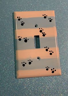 a light switch cover with paw prints on it