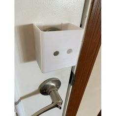 a door handle is attached to the side of a door with a white box on it