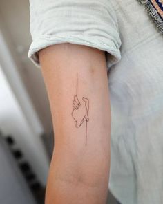 a woman's arm with a small tattoo on the left side of her arm