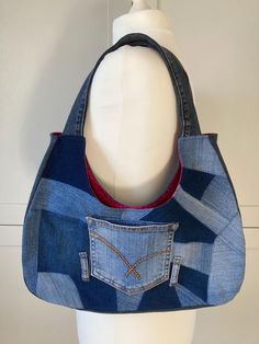 a handbag made from an old pair of jeans is displayed on a mannequin's head