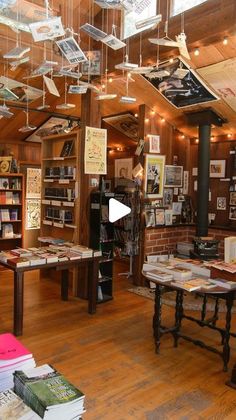 a room filled with lots of books on top of a hard wood floor