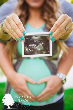 a pregnant woman holding her belly in the shape of a heart with an x - ray