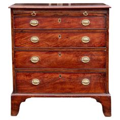 an antique chest of drawers with brass handles