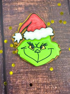 the grin face cookie has been decorated with gold confetti