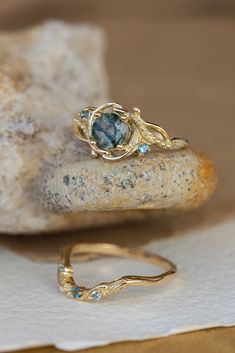 two rings sitting on top of a rock