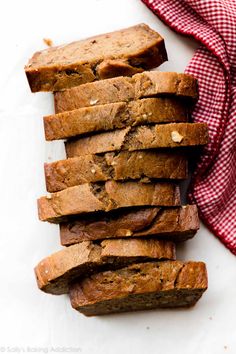 slices of banana bread stacked on top of each other next to a red and white checkered napkin