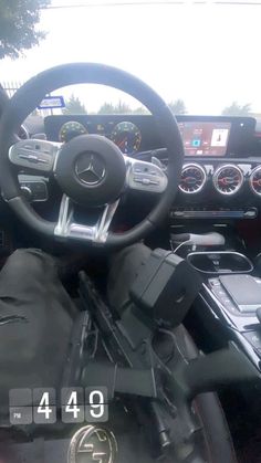 the inside of a car with dashboard and steering wheel, including electronic devices on display