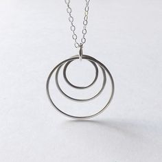 Silver Circle Necklace Three Ring Pendant Circles Geometric Hoop Necklace Handmade womens Jewelry gi Modern Round Hypoallergenic Jewelry, Modern Hypoallergenic Round Jewelry, Modern Hypoallergenic Jewelry, Modern Round Sterling Silver Jewelry, Modern Circle Stainless Steel Jewelry, Modern Full Circle Jewelry Gift, Modern Hypoallergenic Open Circle Jewelry, Modern Sterling Silver Open Circle Jewelry, Nickel-free Open Circle Jewelry Gift