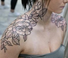 a woman's neck with flowers on it