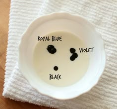 a white bowl with black dots on it and the words royal blue in front of it