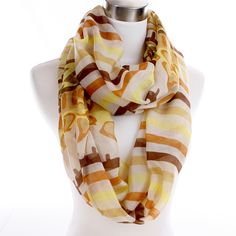 Repeating quartets of brown, tan, yellow and gold stripes abut a border pattern of abstract shapes in similar hues - all woven in a sandy shade of white. A great warm-weather infinity scarf.This perfect-for-summer-wear infinity scarf is woven in a feather-weight viscose rayon – a silky smooth fabric created from wood pulp – and measures approximately 19.5” wide with a circumference of 72”. Tan And White Striped Scarf, Border Pattern, Gold Stripes, Shades Of White, Style Expert, Summer Wear, Infinity Scarf, Warm Weather, Stripes