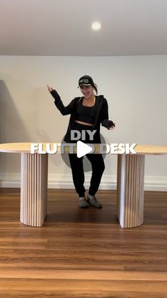 a woman standing in front of a round table