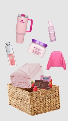 the contents of a basket with pink items in it, including a mug and other items