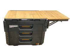 a tool box with three drawers and a wooden table top on the bottom shelf is shown