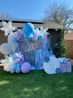 a frozen princess birthday party with balloons and streamers on the front lawn at a home