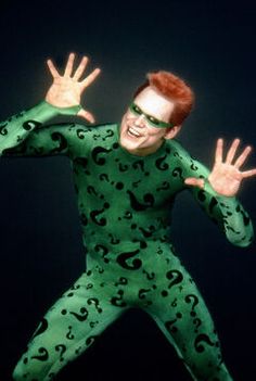 a man in a green costume with his hands out