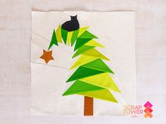 a paper christmas tree with a black cat on top