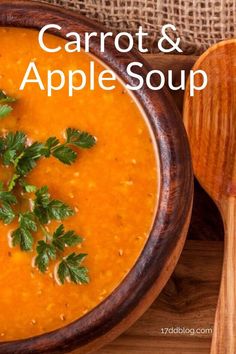 carrot and apple soup in a wooden bowl with parsley