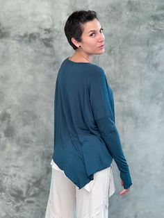 caraucci plant-based rayon jersey teal blue asymmetrical hem oversized long sleeve top with thumbholes #color_teal Versatile Long Sleeve Top With Soft Stretch, Versatile Soft Stretch Long Sleeve Top, Long Sleeve Lagenlook Tops For Layering, Asymmetrical Stretch Long Sleeve Top For Fall, Stretch Viscose Long Sleeve Tops, Versatile Flowy Tops For Loungewear, Versatile Viscose Tops For Layering, Casual Asymmetrical Tops For Loungewear, Long Sleeve Modal Tops For Fall