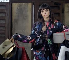 a woman holding shopping bags in her hands