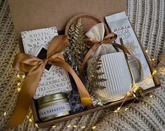 an open gift box with candles, cookies and other items