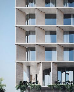 a tall building with many windows and balconies