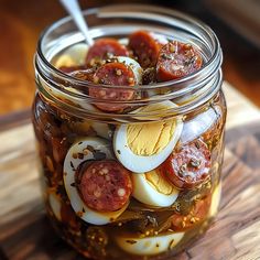 a glass jar filled with food sitting on top of a wooden cutting board