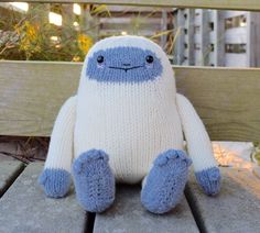 a stuffed animal sitting on top of a wooden bench