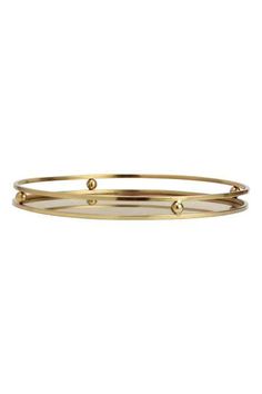 a gold plated bang bracelet with three balls on the side and two holes in the middle