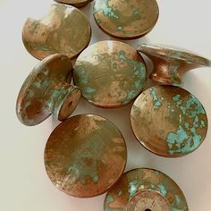 several pieces of pottery sitting on top of a white table next to each other,