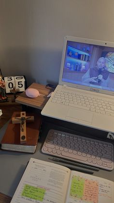 an open laptop computer sitting on top of a desk